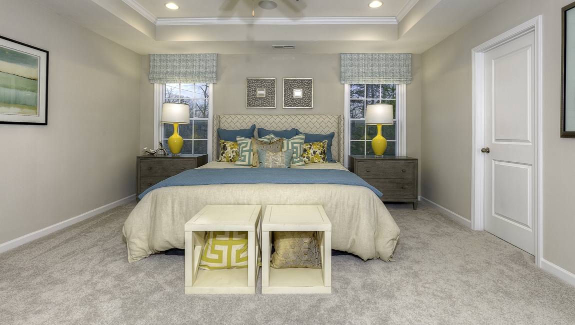 Primary suite carpeted with two windows