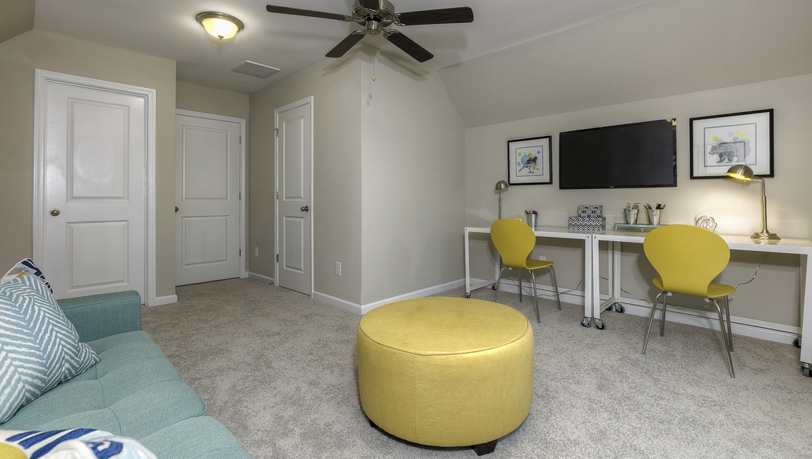 Carpeted bonus room with large window