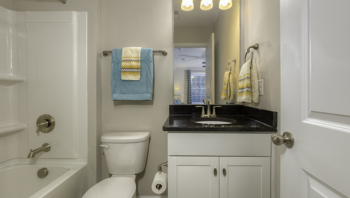 Bathroom with bathtub and white cabinet