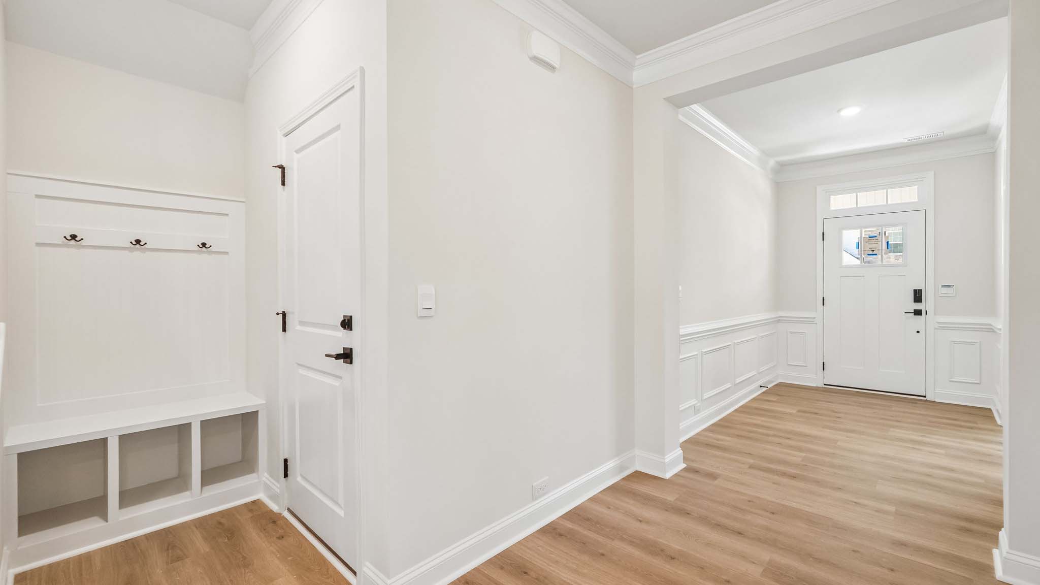 Welcoming foyer with wood floors, and view of entrance hallway