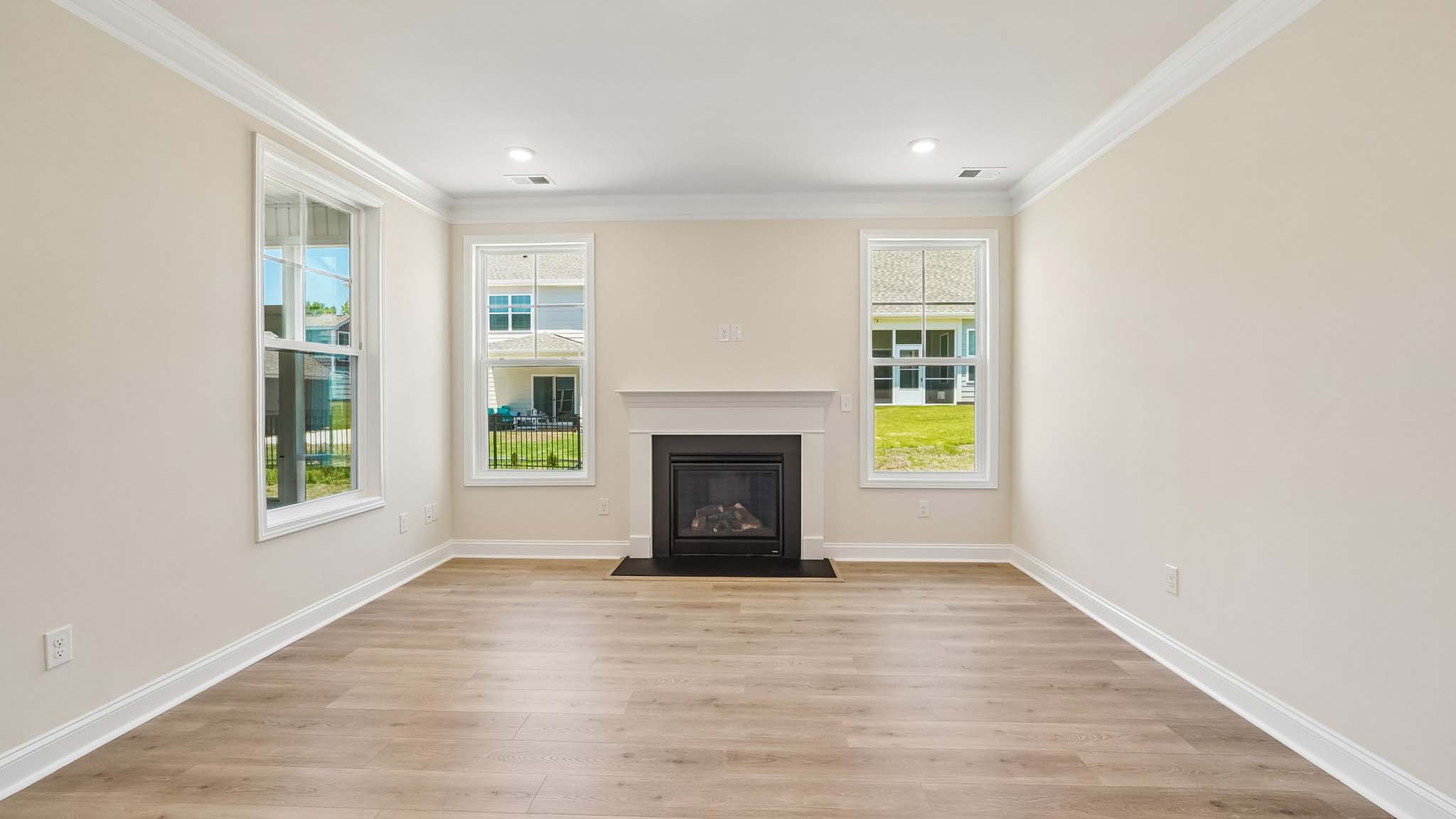 Open family room with two large window and fireplace