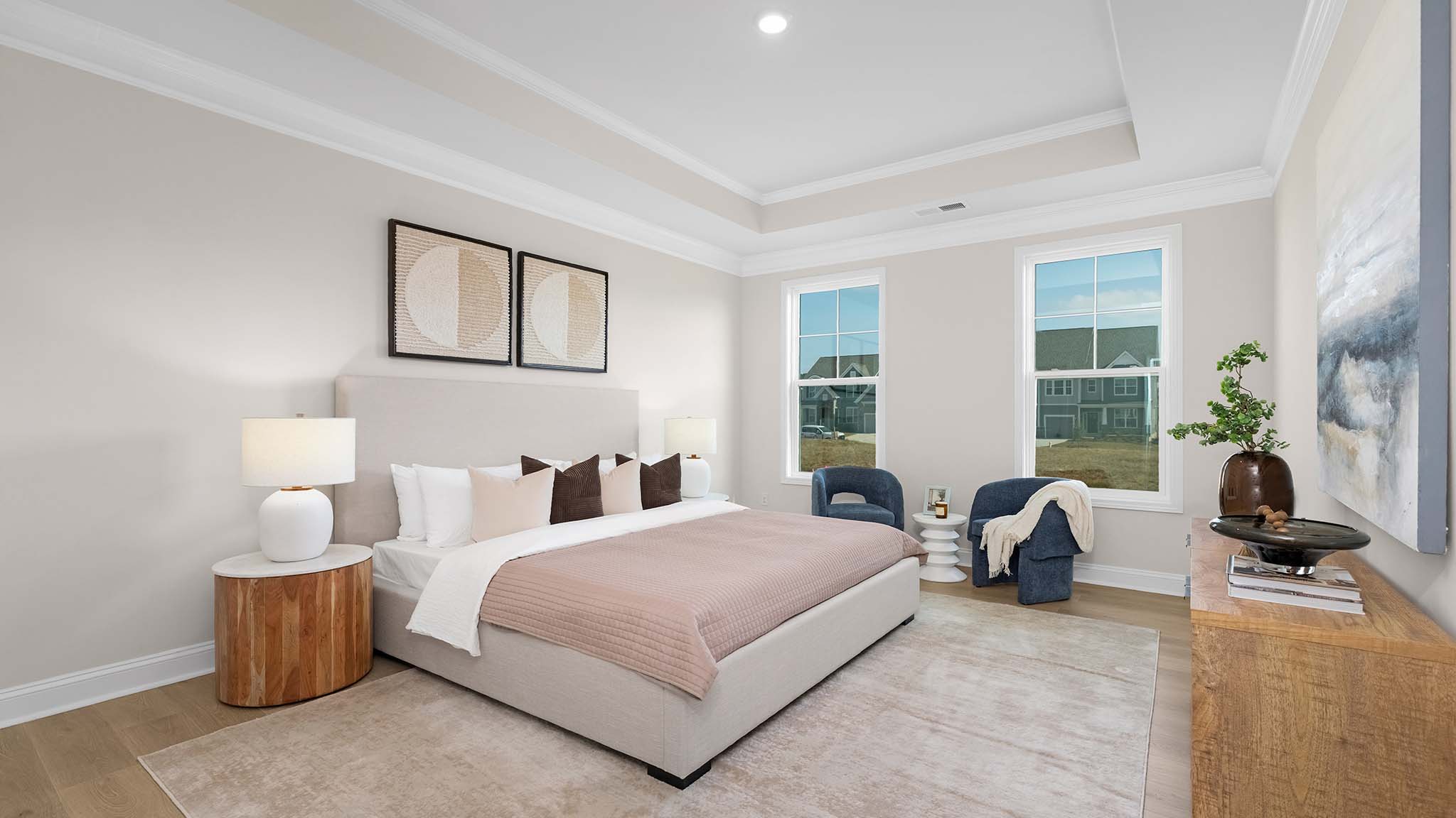Primary bedroom with carpet, and two large windows