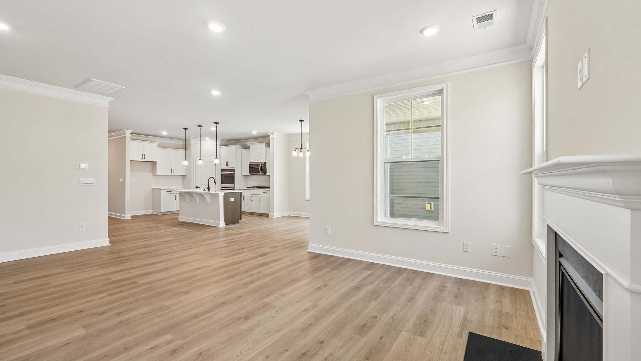 Open family room with two large window and fireplace