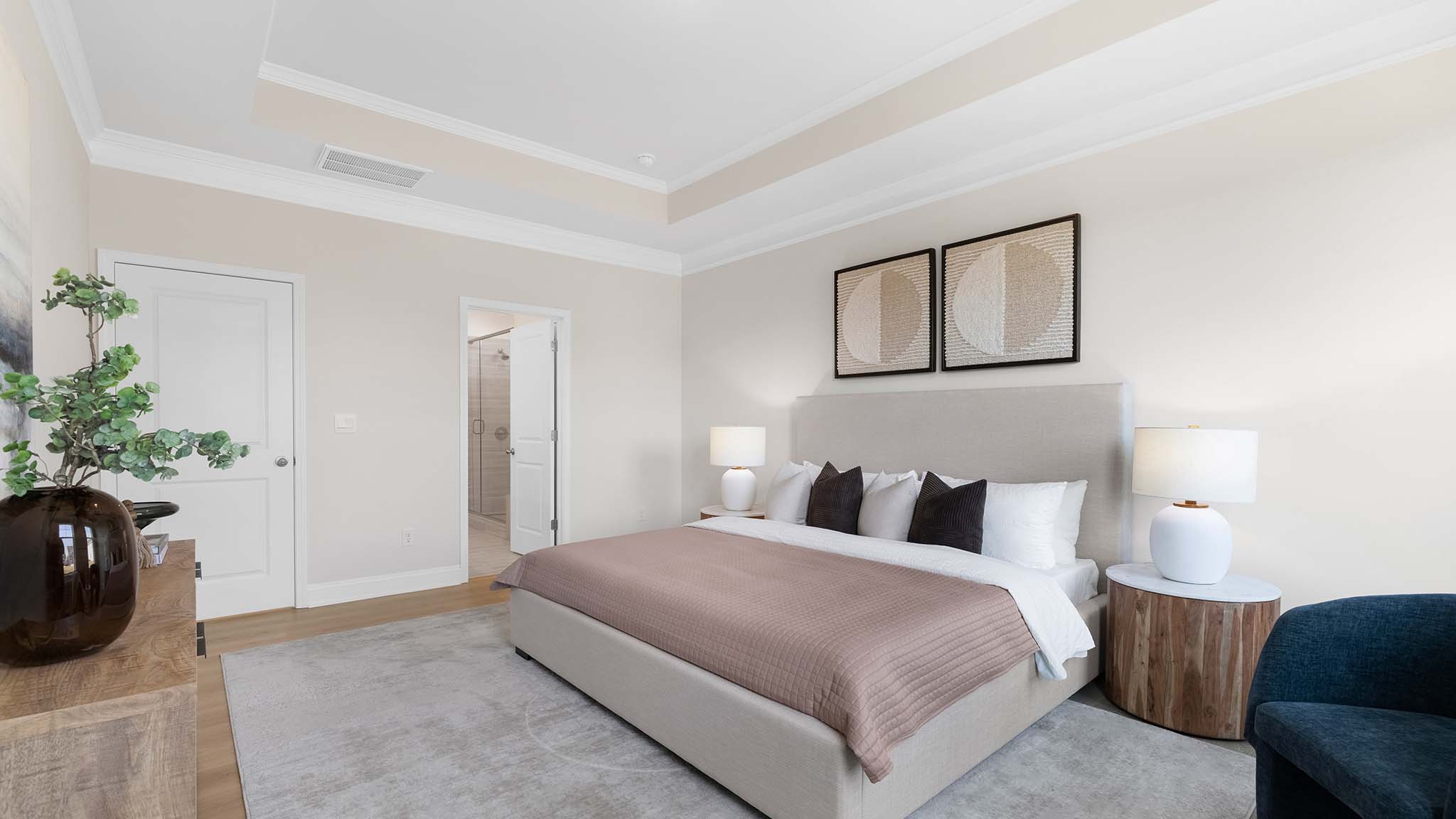 Primary bedroom with carpet, and two large windows