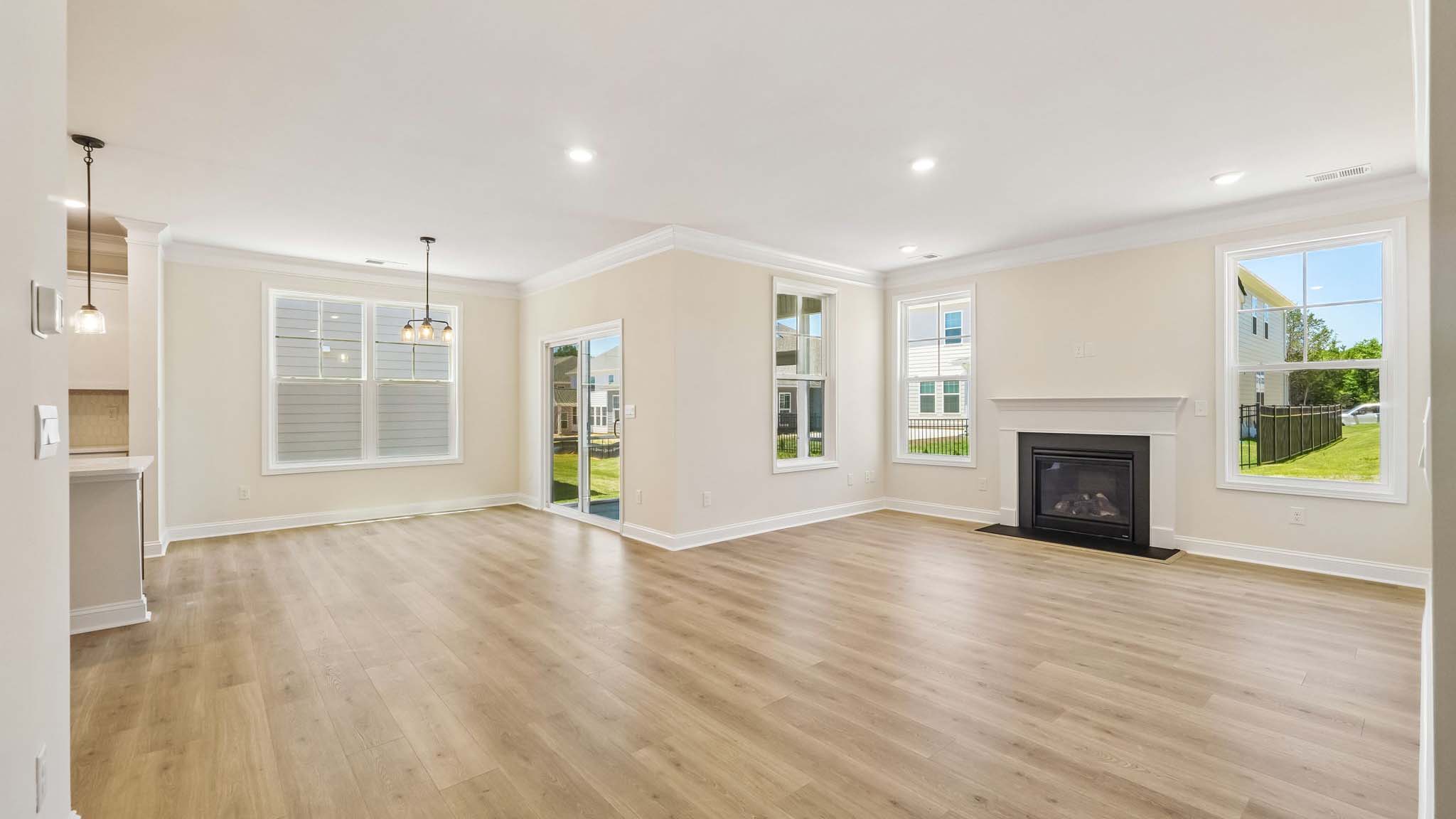 Open family room with two large window and fireplace