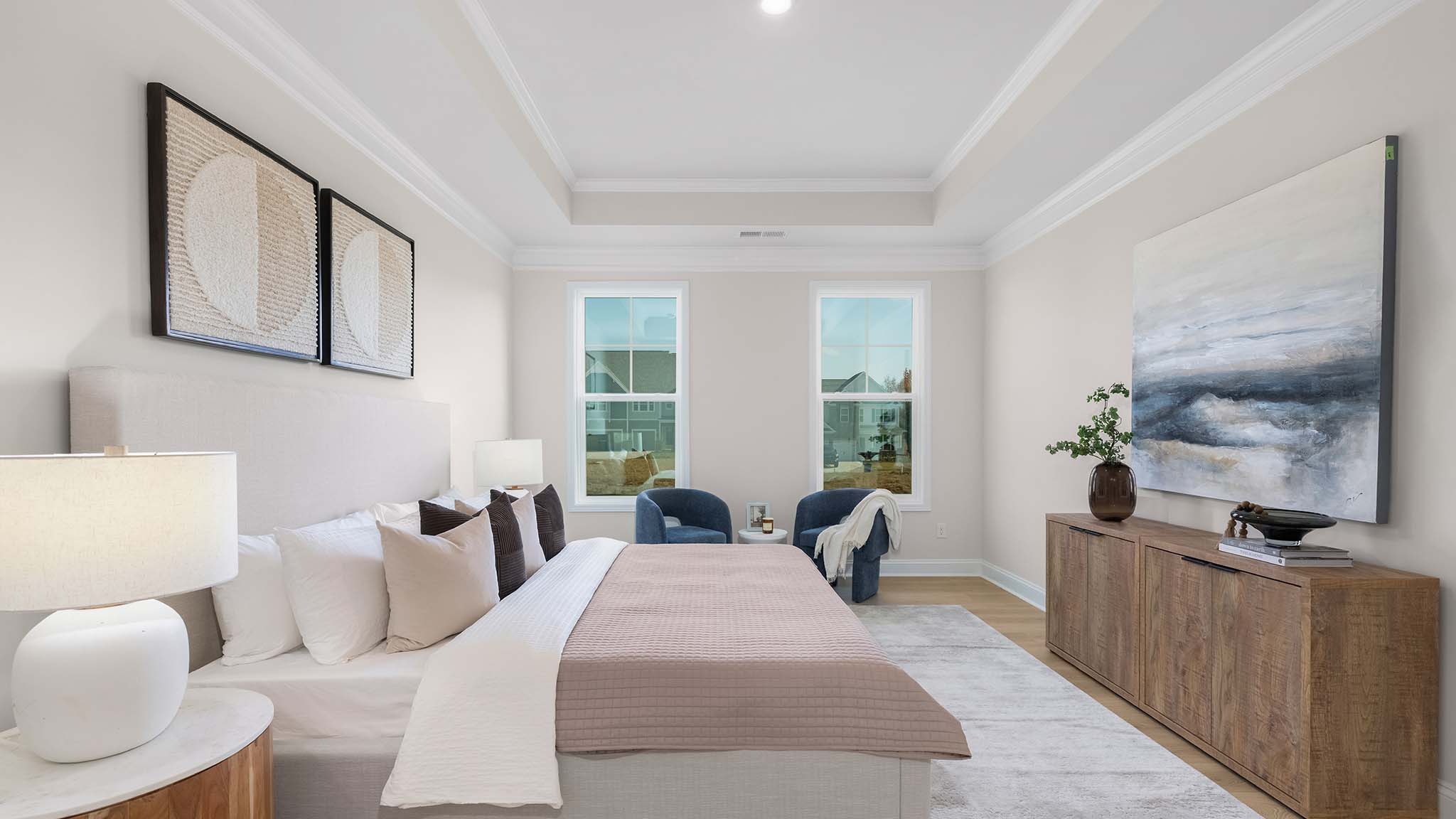 Primary bedroom with carpet, and two large windows