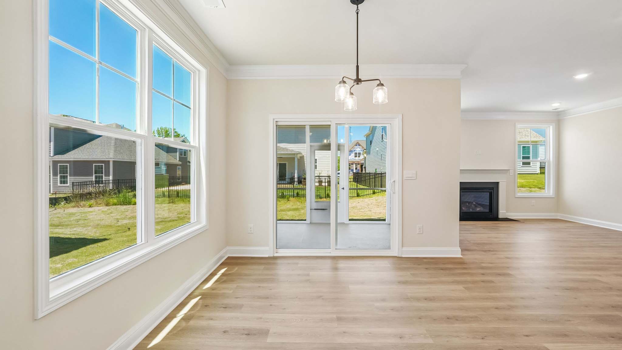 Eating area beside kitchen, wood floors, and sliding glass back door