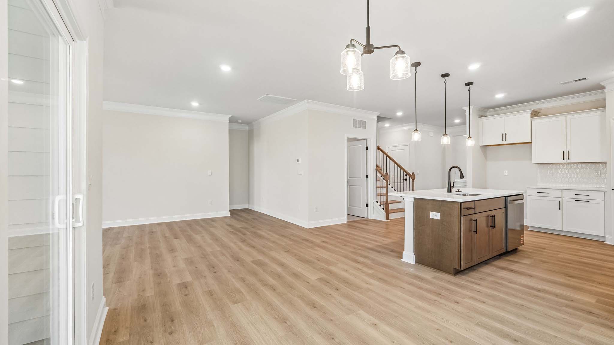Eating area beside kitchen, wood floors, and sliding glass back door