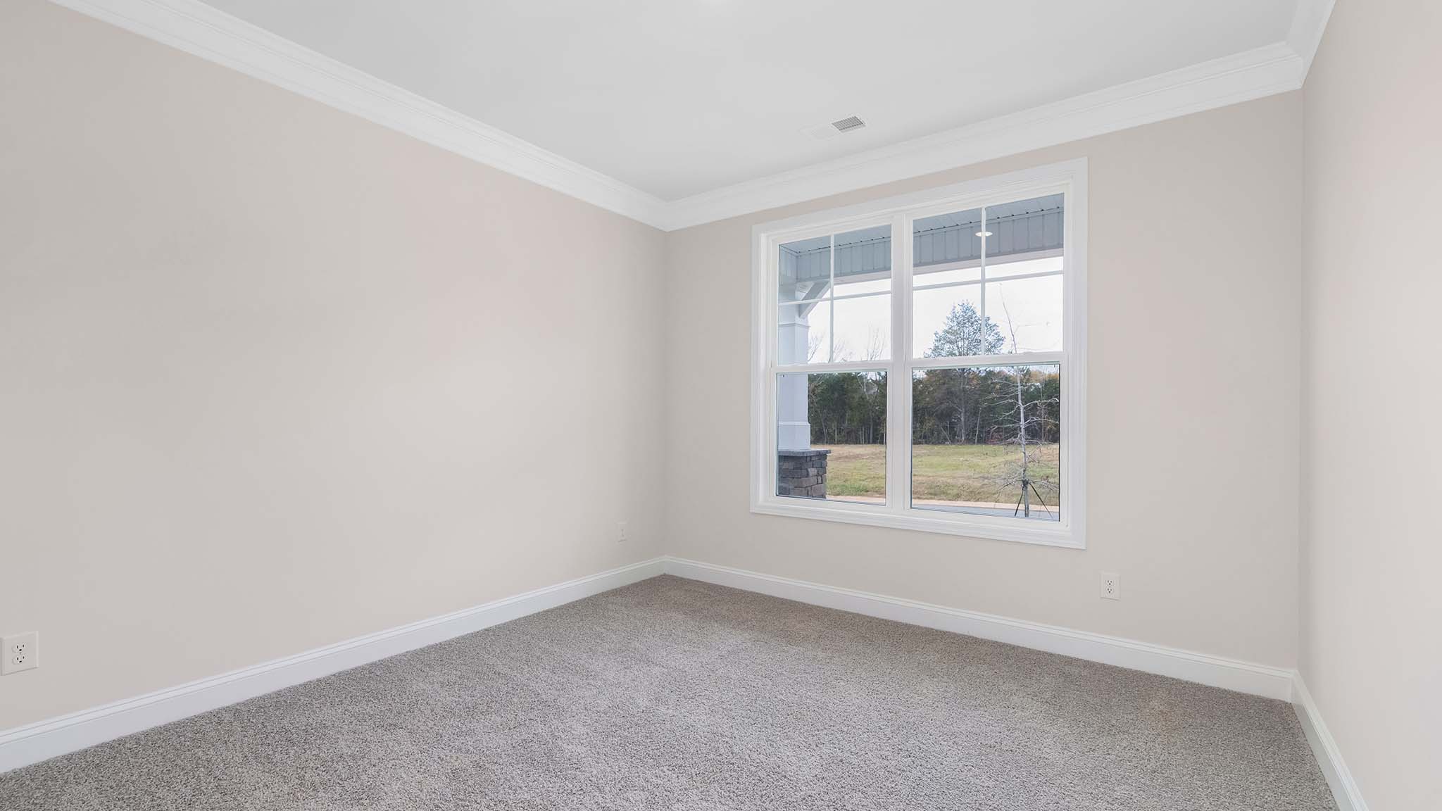 Carpeted bedroom with large windows