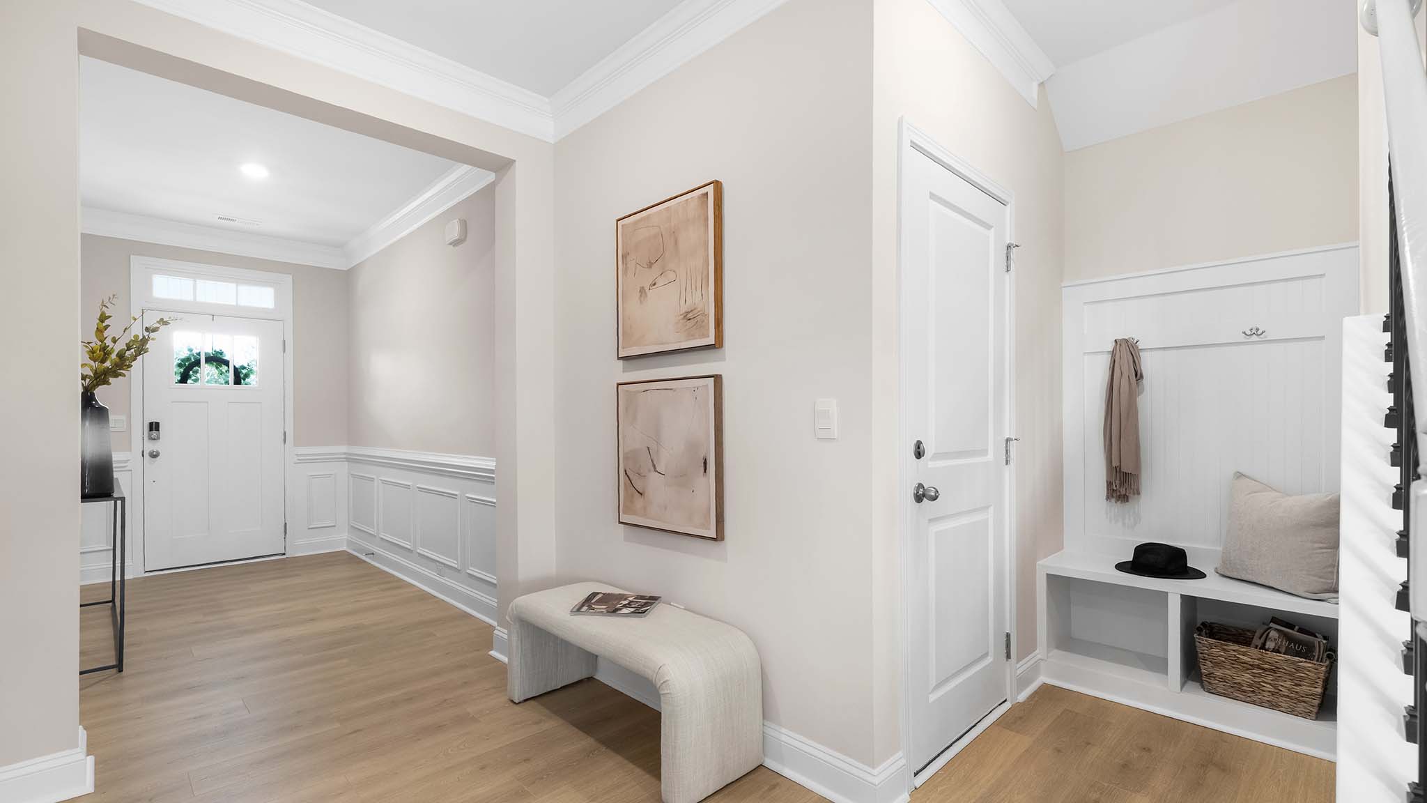 Welcoming foyer with wood floors, and view of entrance hallway