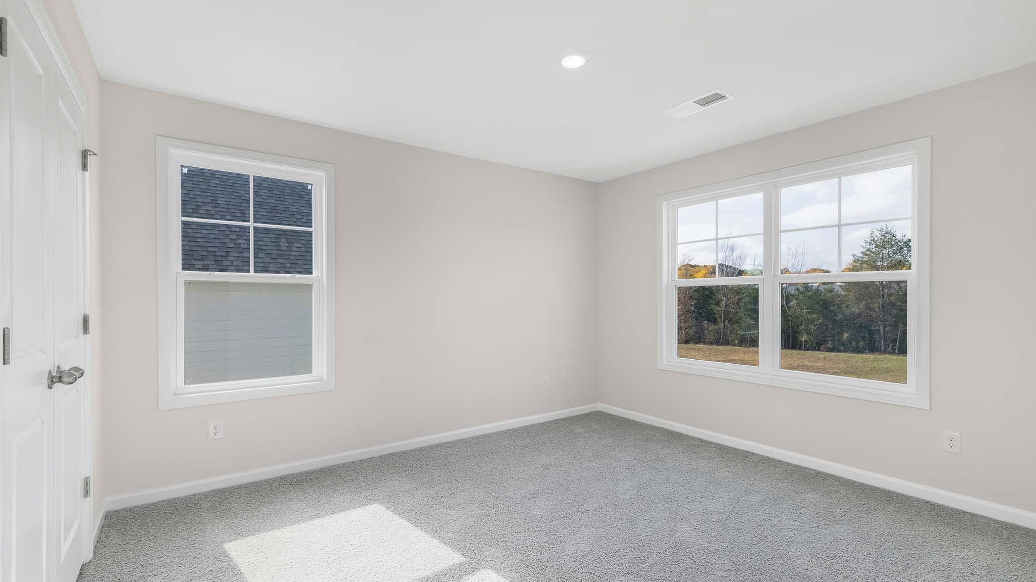 Carpeted bedroom with  small window
