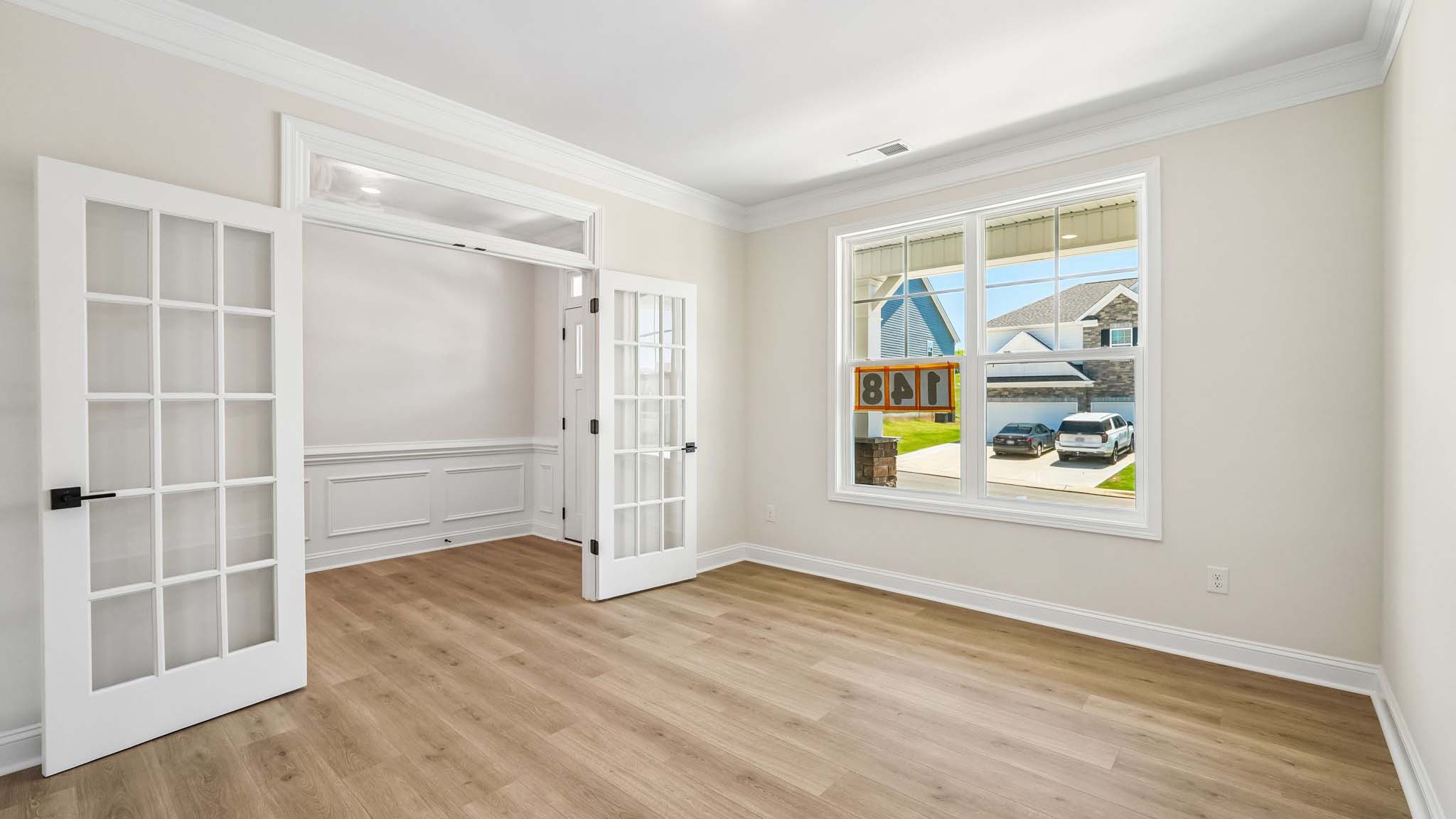 Dining room with wood floors, and large window