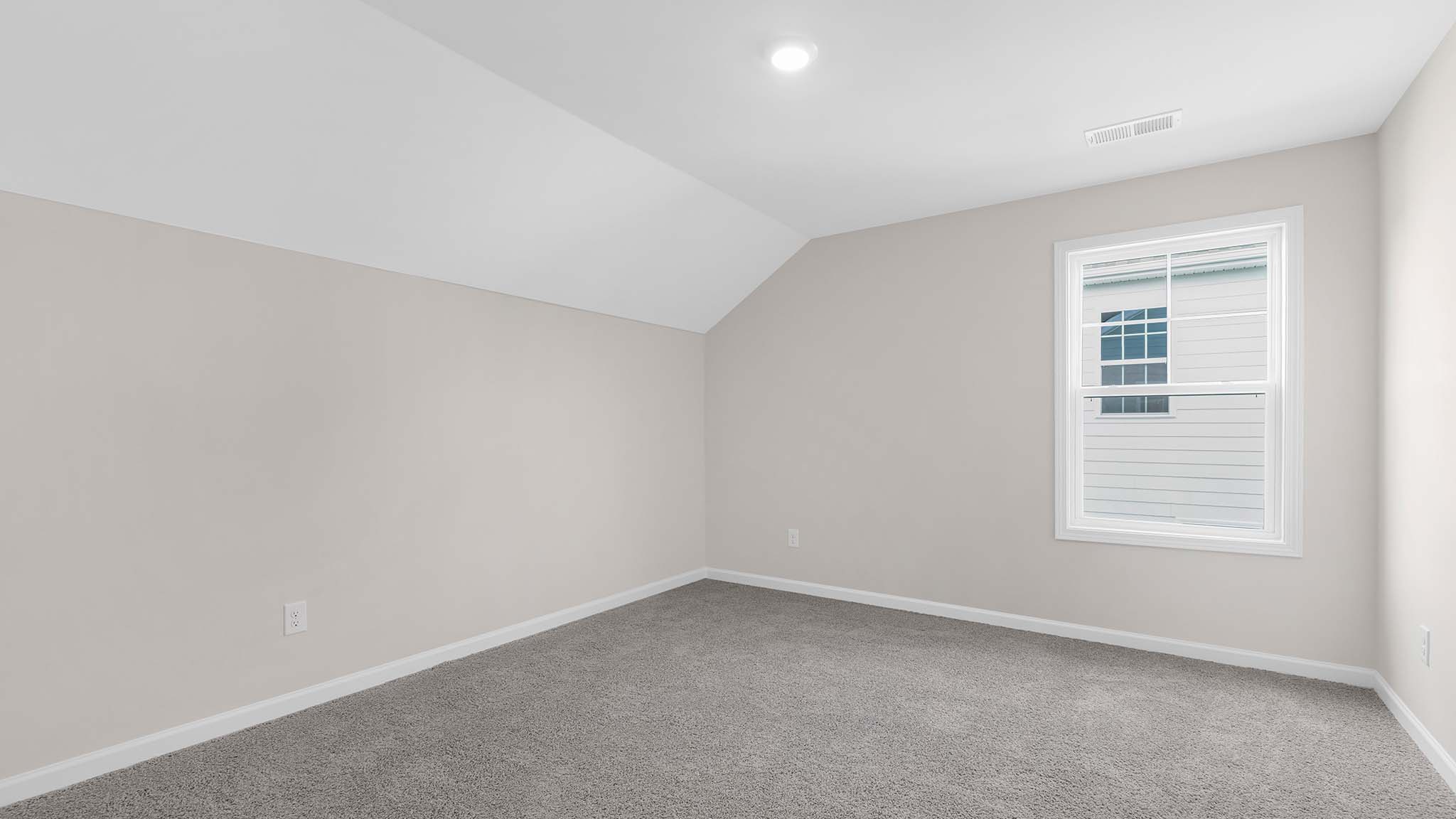 Carpeted bedroom with  small window