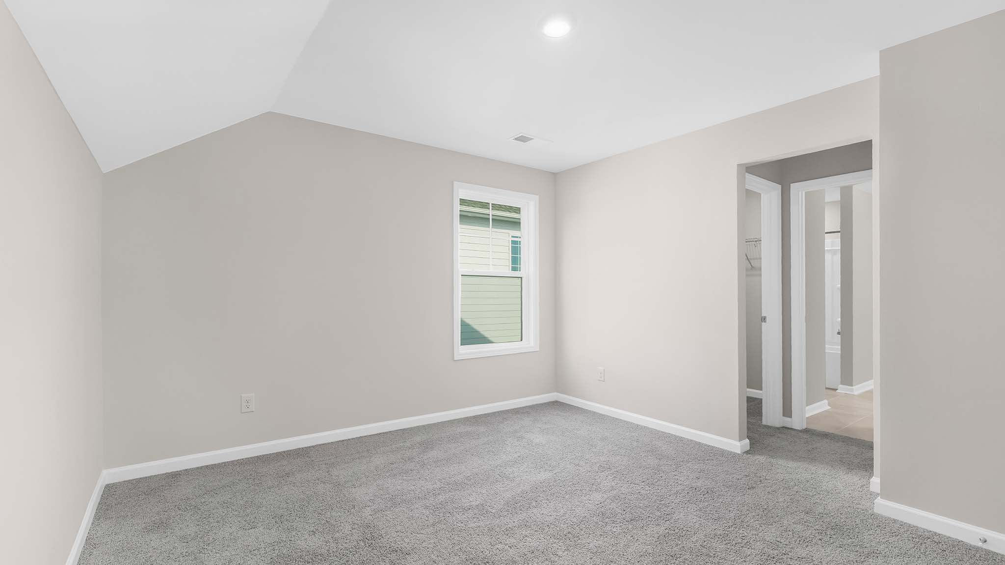 Carpeted bedroom with  small window