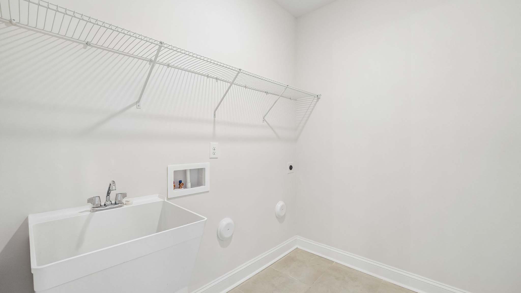 Laundry room with racks above machines for storage and hanging