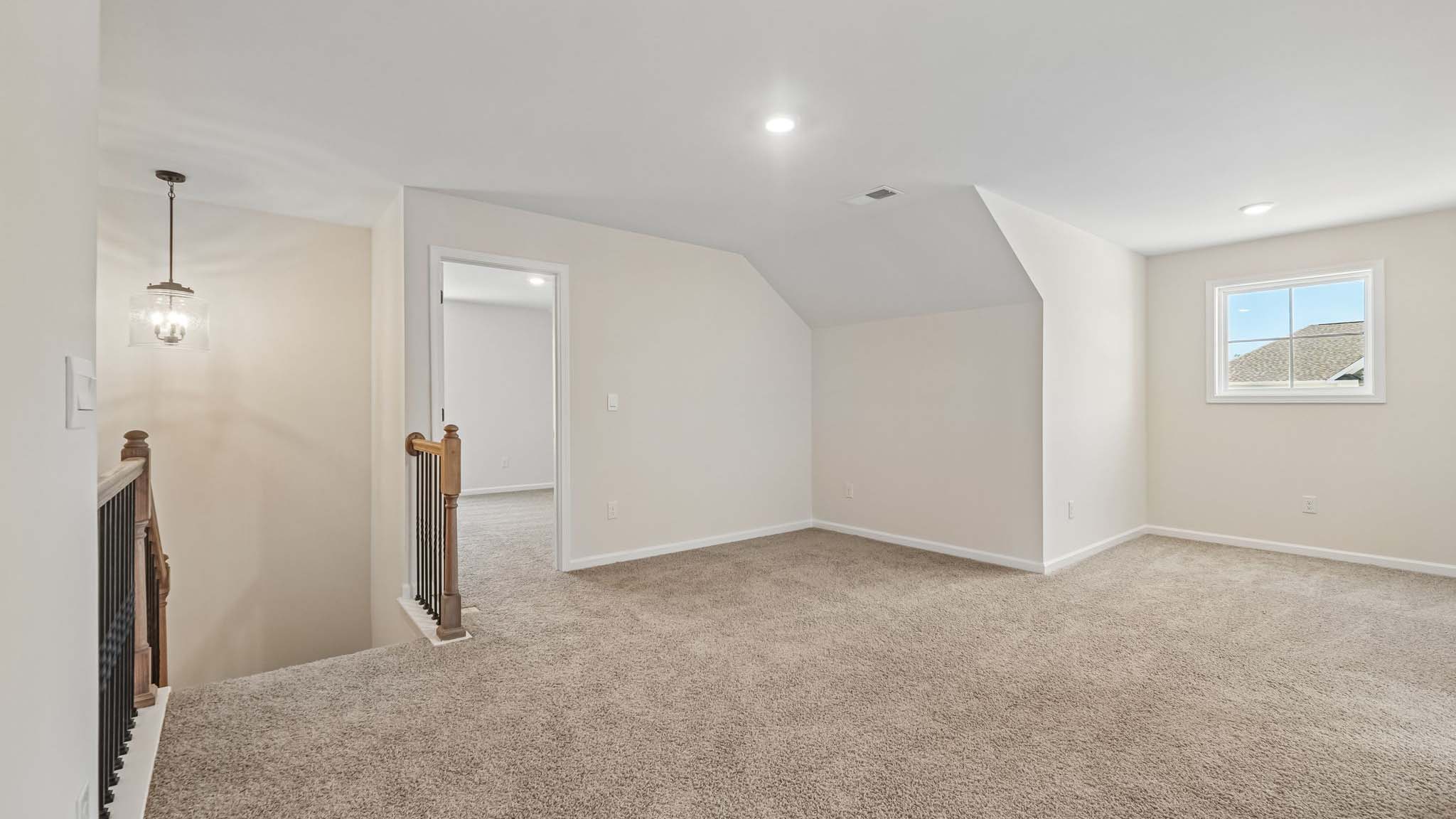 Carpeted bedroom with large windows