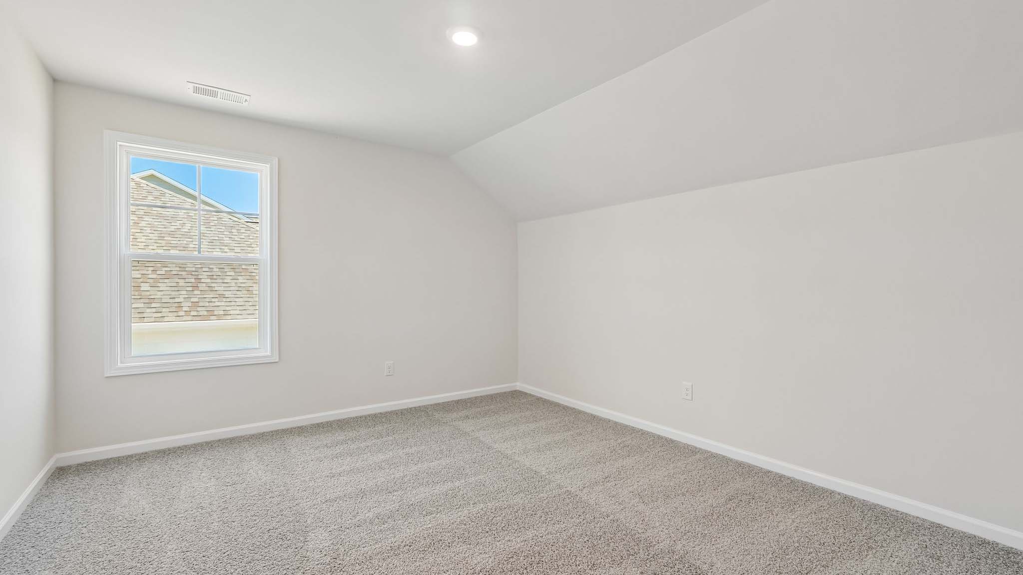 Carpeted bedroom with large windows