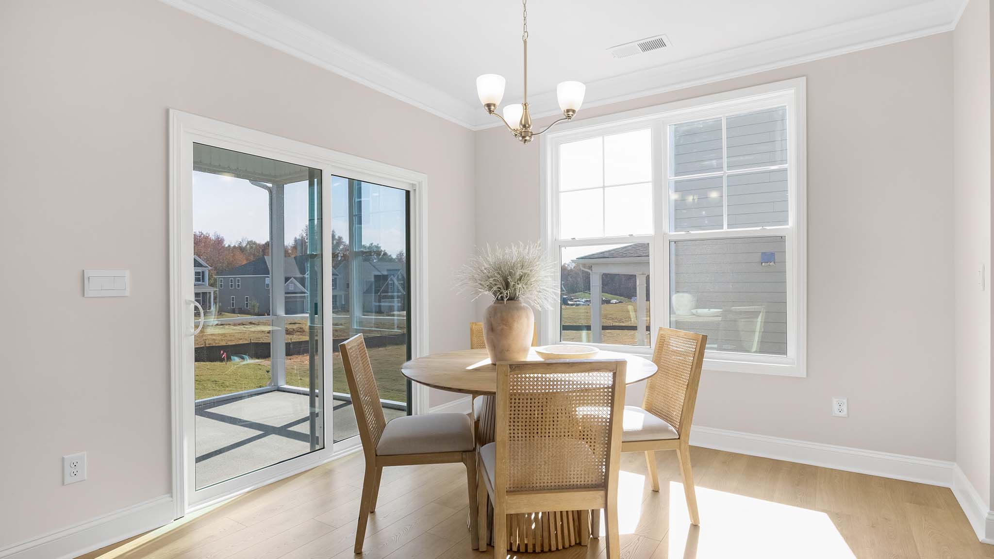 Eating area beside kitchen, wood floors, and sliding glass back door