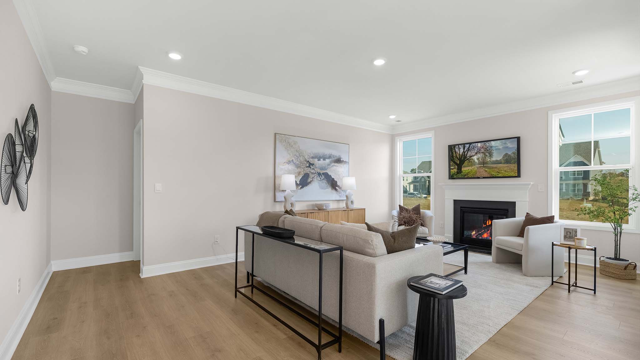 Open family room with two large window and fireplace