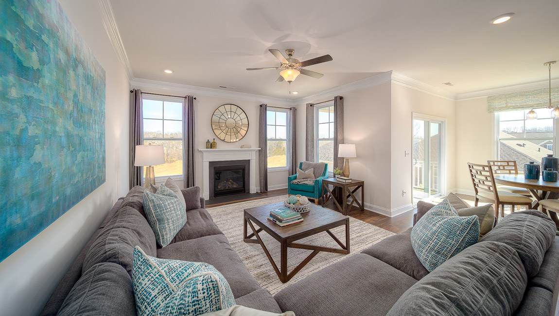 Open family room with two large window and fireplace
