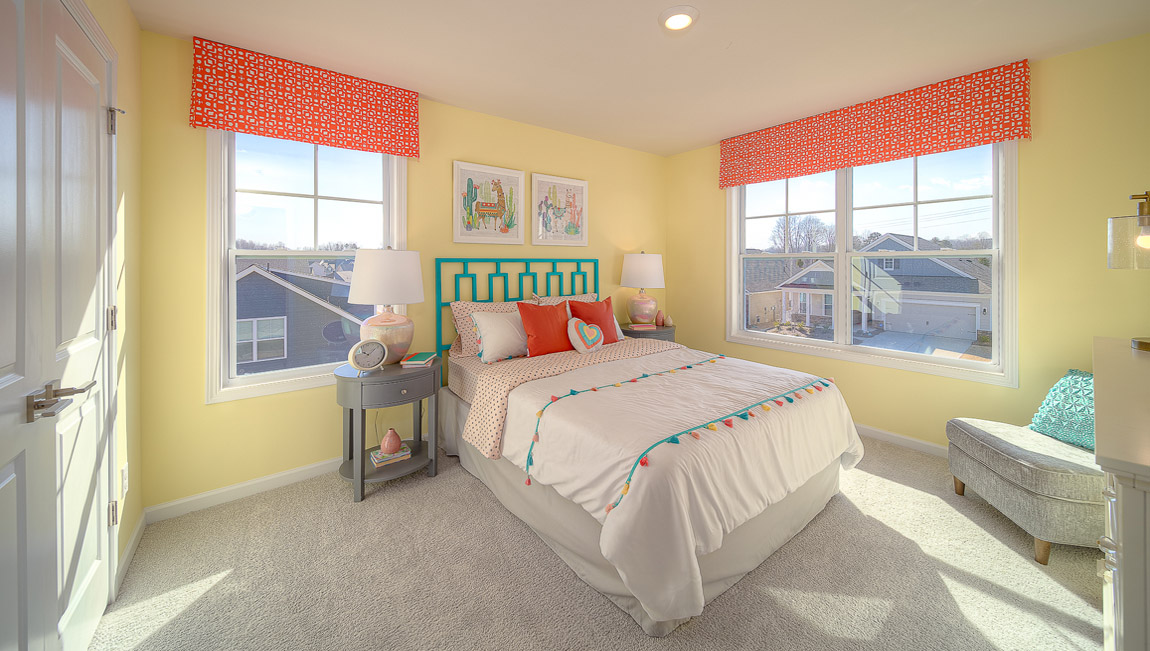 Carpeted bedroom with large windows