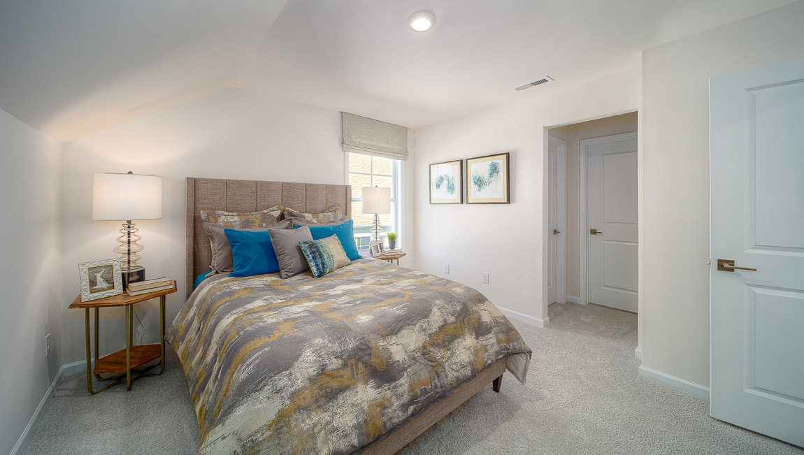 Carpeted bedroom with small window