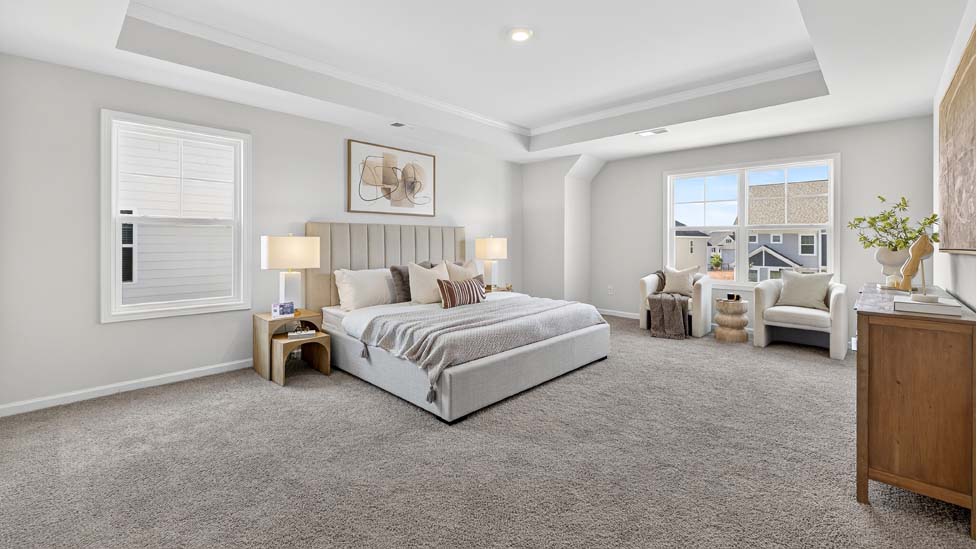 Primary bedroom with carpet and large windows