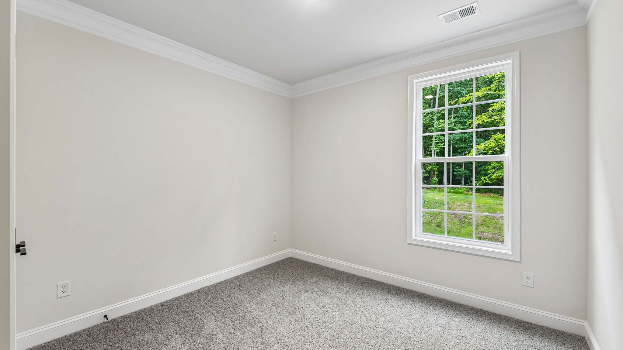 Carpeted bedroom with large window