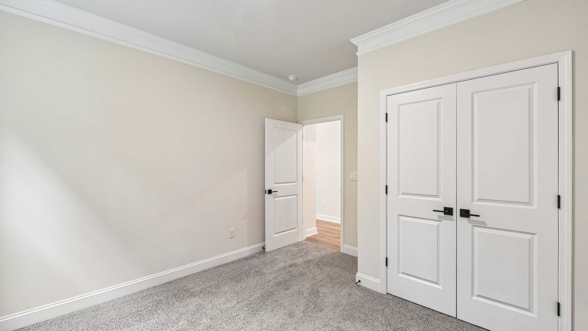 Carpeted bedroom with large window