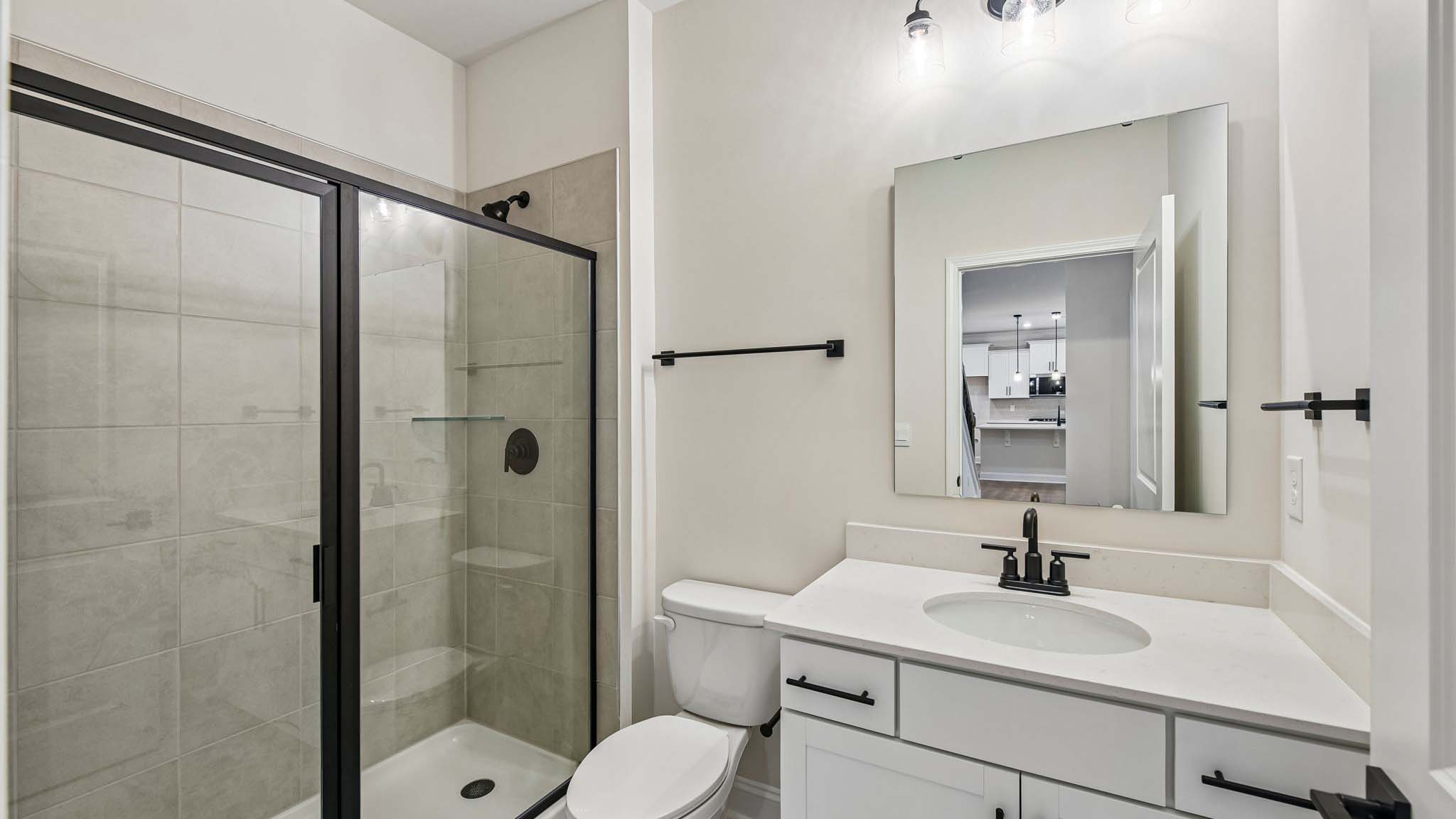 Bathroom with single sink and standing glass shower