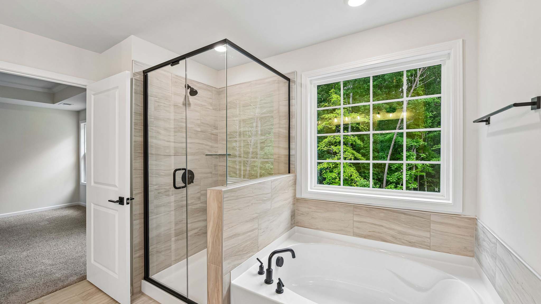 Primary bathroom with double sinks and standing glass shower