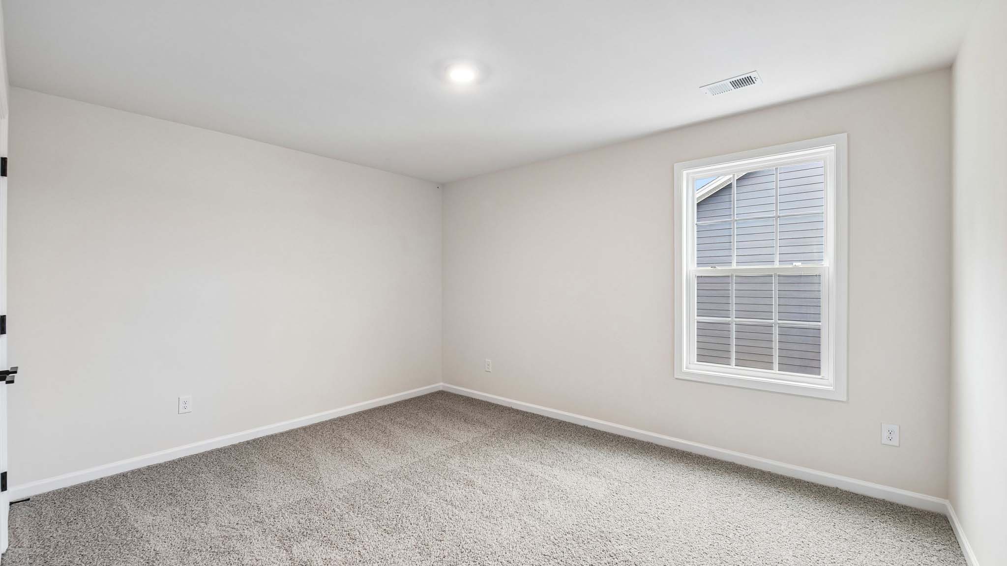 Carpeted bedroom with large window