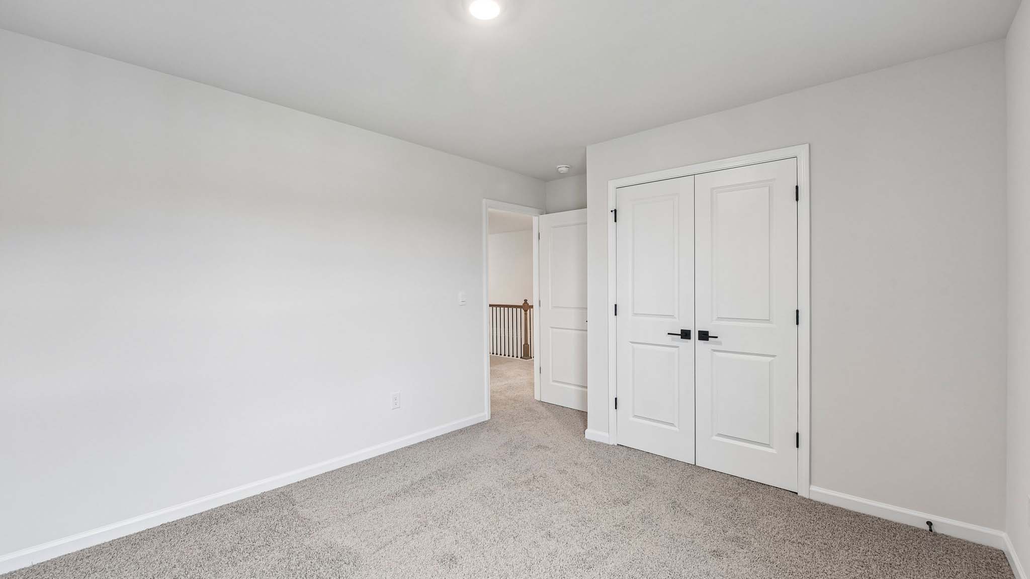 Carpeted bedroom with large window