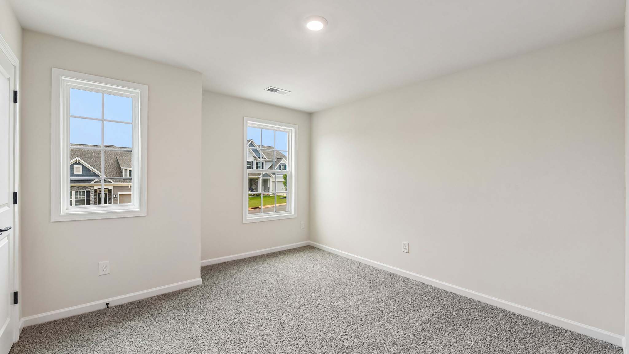 Carpeted bedroom with large window