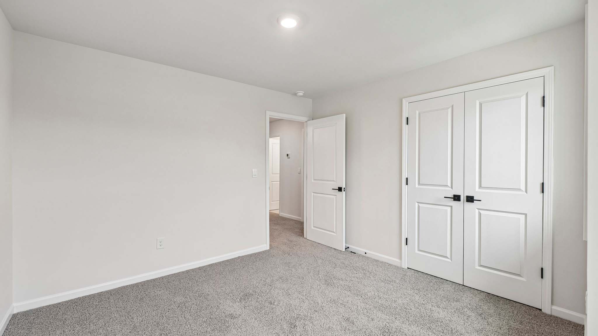 Carpeted bedroom with large window