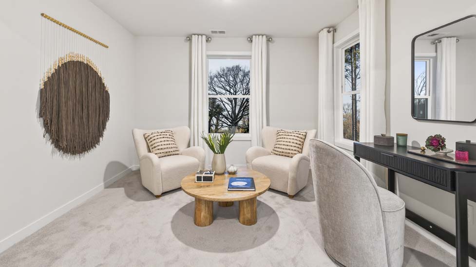 Carpeted primary bedroom with large windows