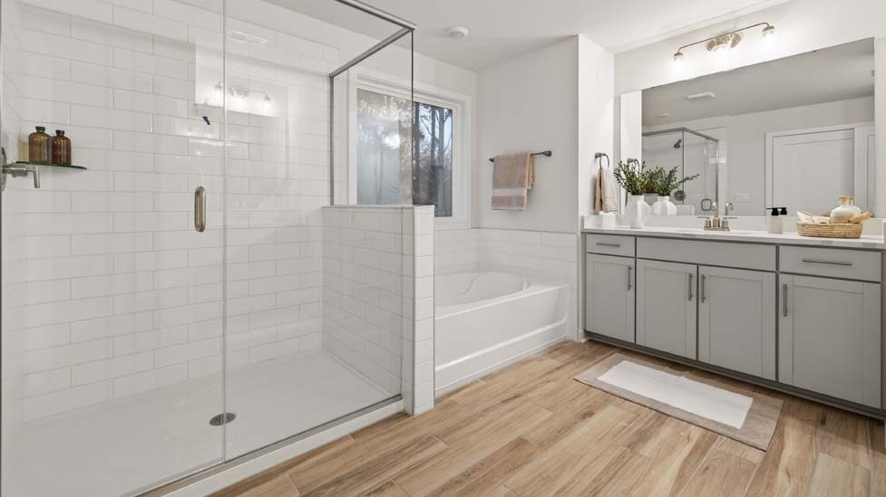 primary bathroom with walk in shower and dual sink vanity