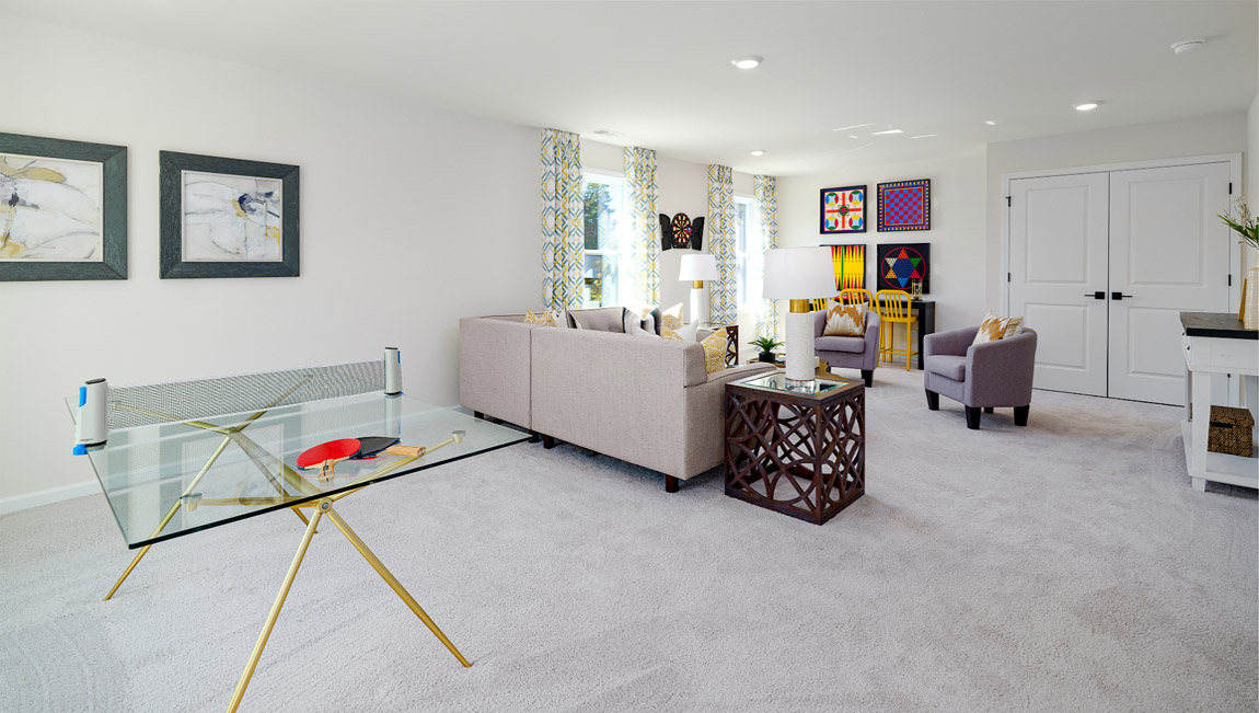 Loft space with carpet and two large windows