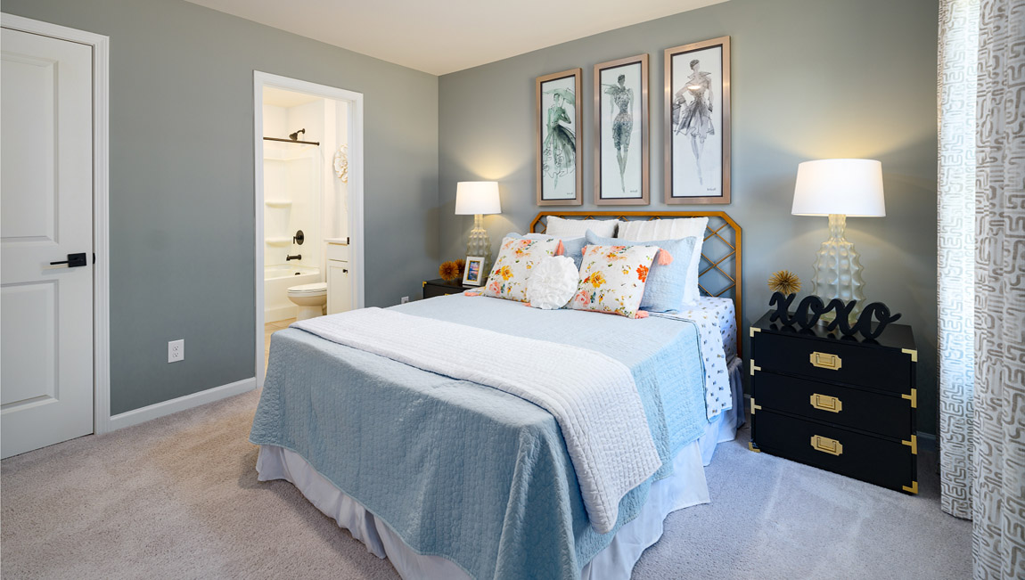 Carpeted bedroom with medium window, being used as an office