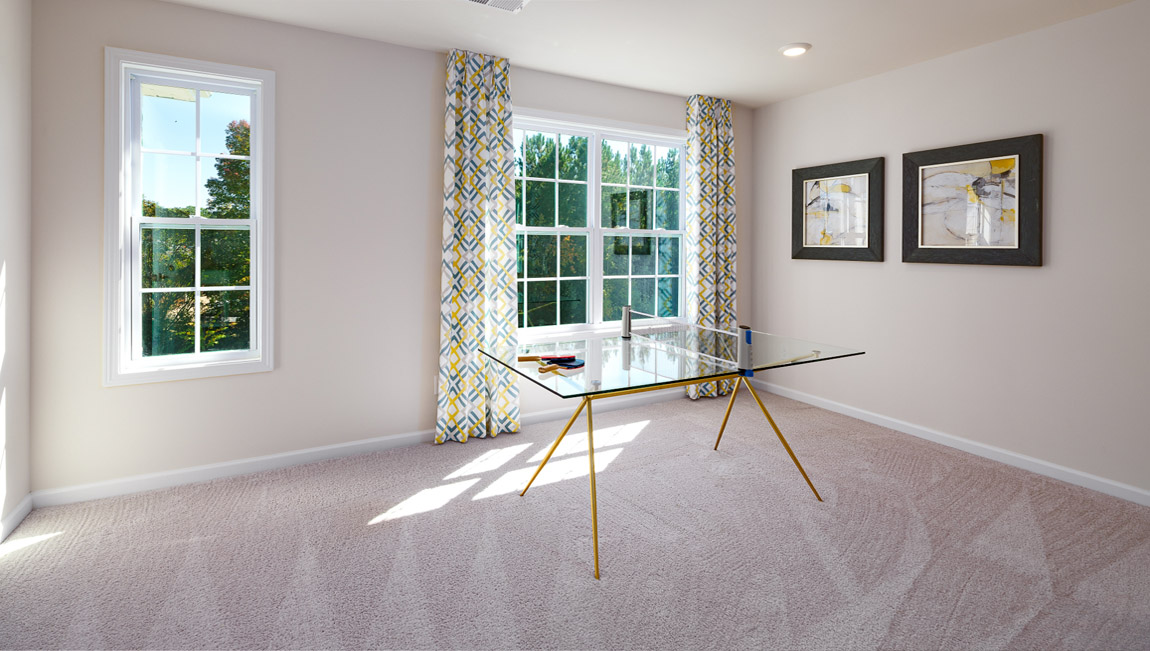 Carpeted bedroom with medium window, being used as an office