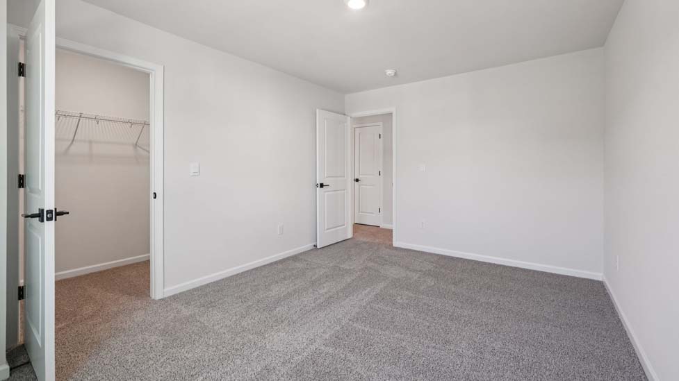 Carpeted bedroom with small window