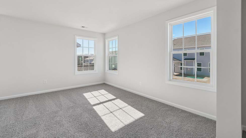 Carpeted bedroom with small window