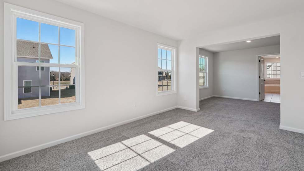 Carpeted bedroom with small window