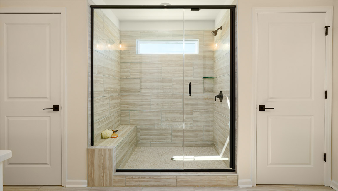 Primary bathroom with separate vanities and standing shower