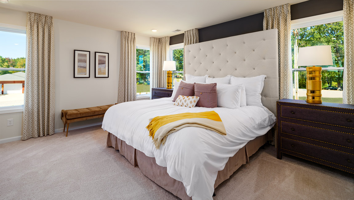 Primary bedroom, carpeted, with three windows