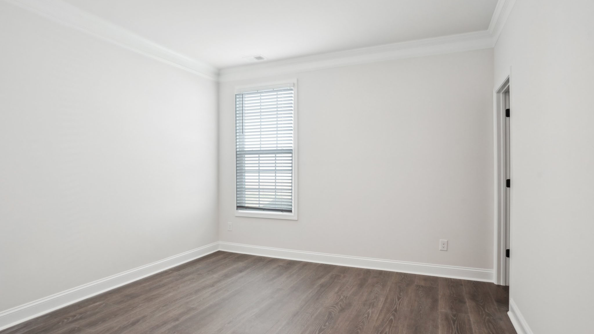 Carpeted bedroom with ceiling fan and small window