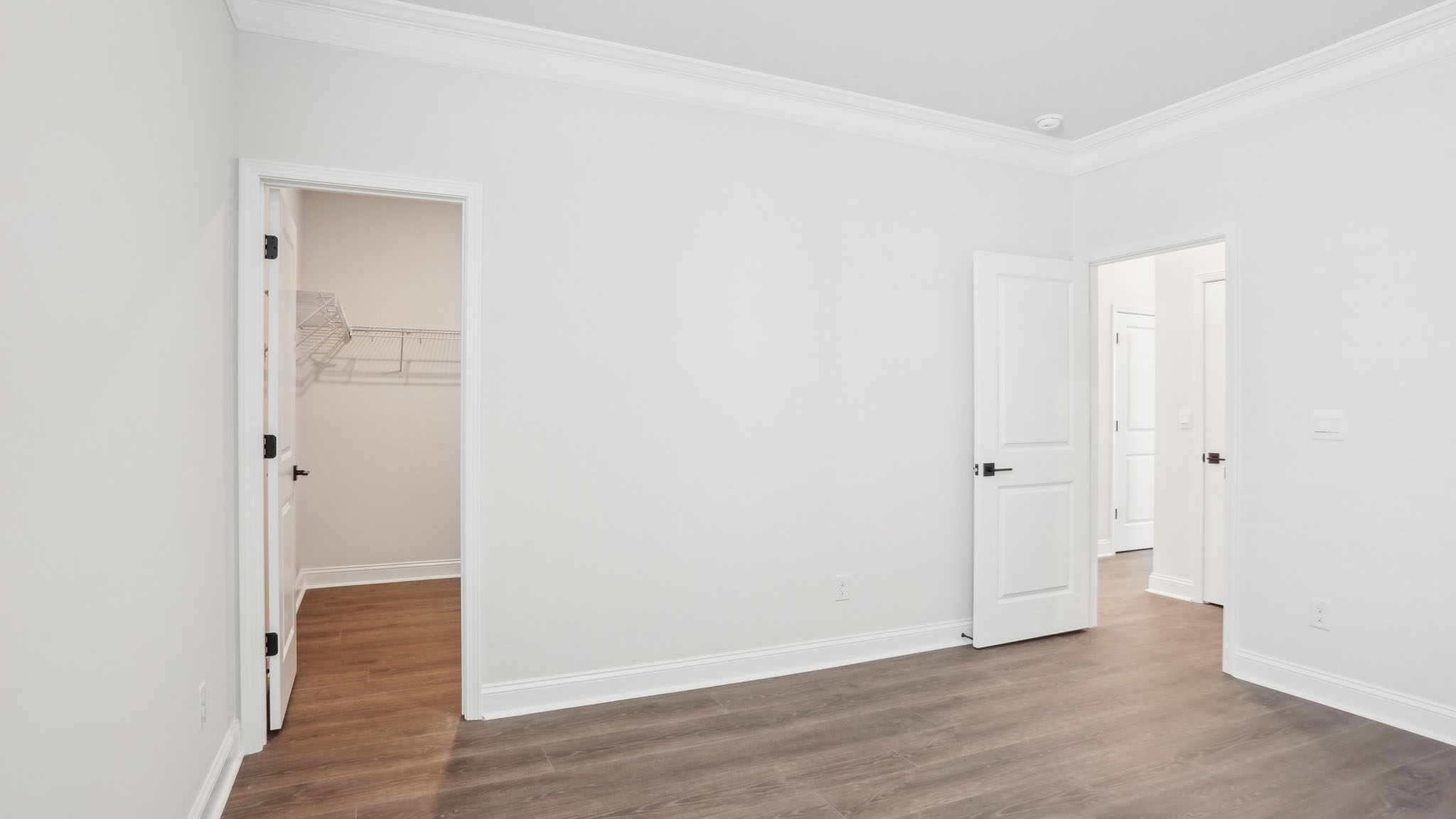 Carpeted bedroom with ceiling fan and small window