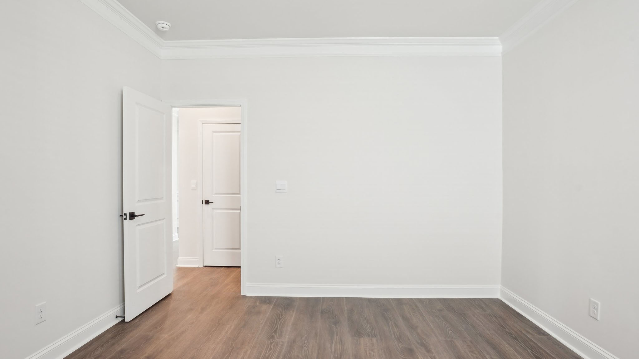 Carpeted bedroom with ceiling fan and small window