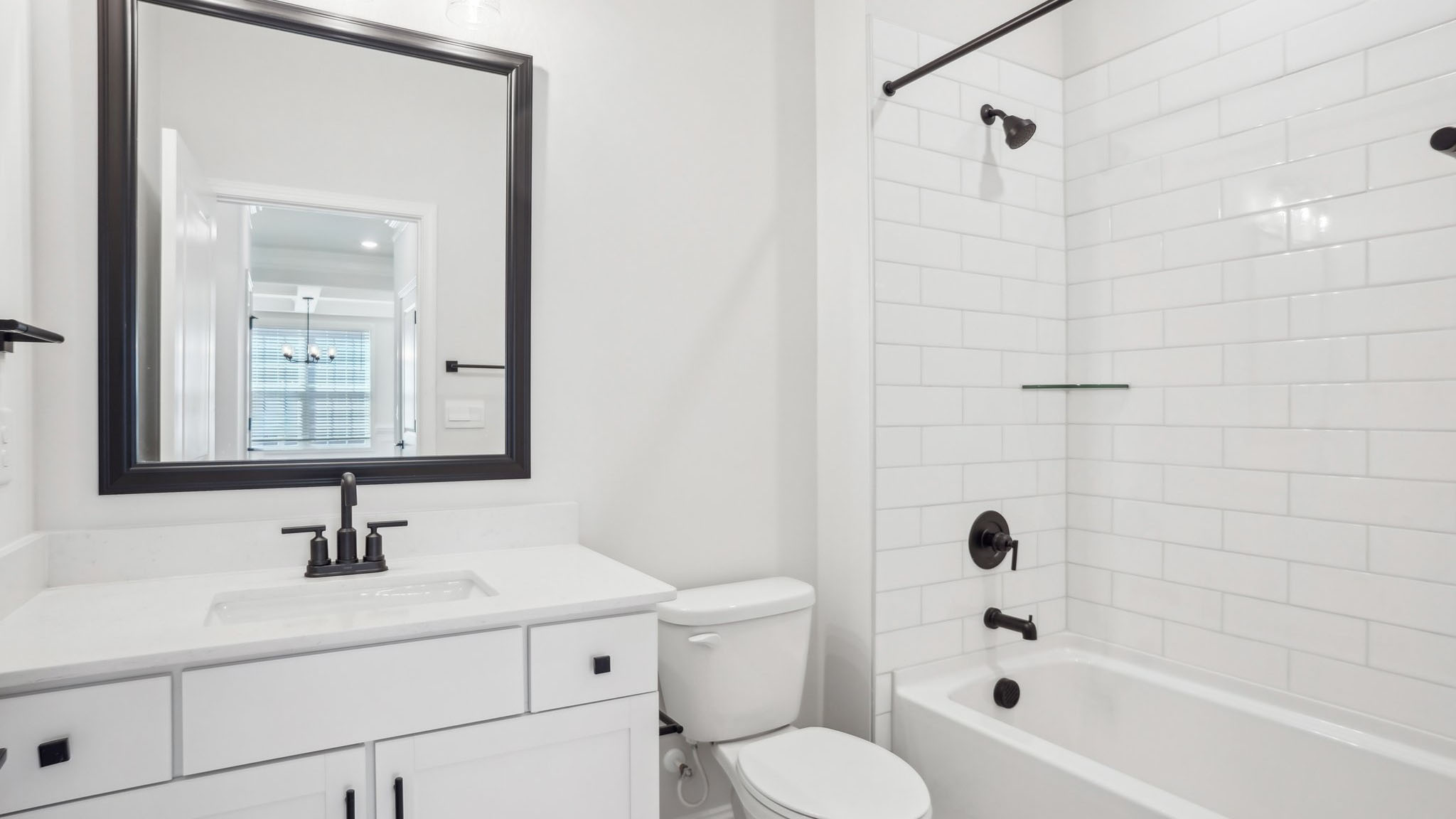 Bathroom with brown cabinets, and a bathtub shower combination