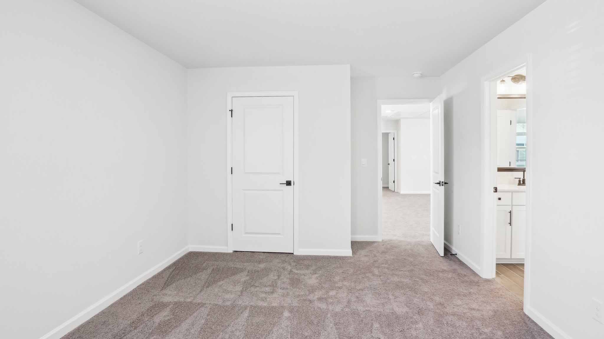 Carpeted bedroom with ceiling fan and small window